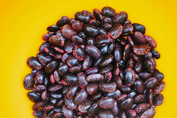 Scarlet runner beans on vibrant yellow background
