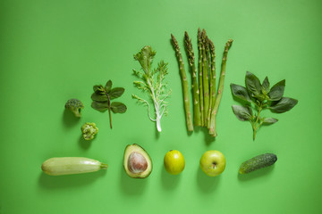 Detox concept, healthy green vegetable smoothie ingredients on green background.