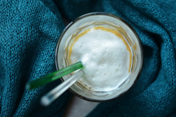 Coffee with foam in a glass on a sweater