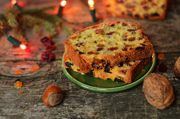 Sliced pieces of the fruitcake on a wooden background