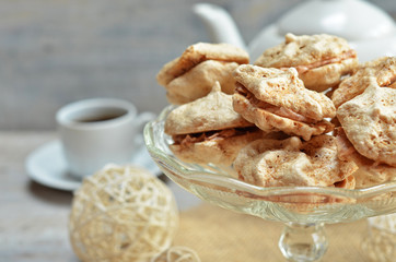 Meringues with nut cream on a glass plateau