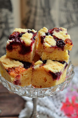 Square pieces of yeast dough with cherries and crumble
