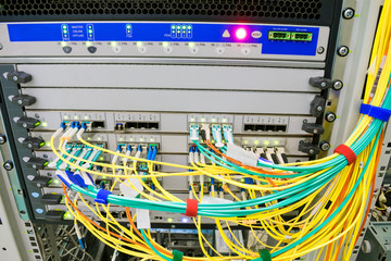 Fiber-optic wires are connected to a central router. The backbone server of the Internet provider....