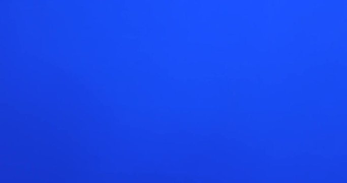 Male fingers grabbing and pulling something invisible toward him on blue screen