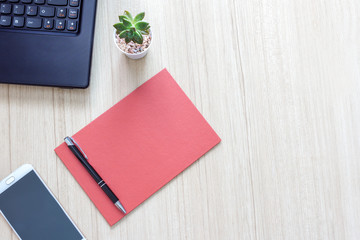 Wood office desk table with laptop,smartphone, paper for note and pen with copy space. 