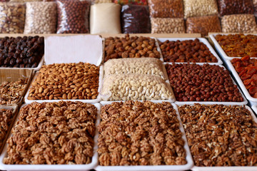 Nuts and dried fruits, on the market counter.
