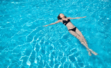 Girl relax in the pool. Beautiful girl as a concept and idea of relax time