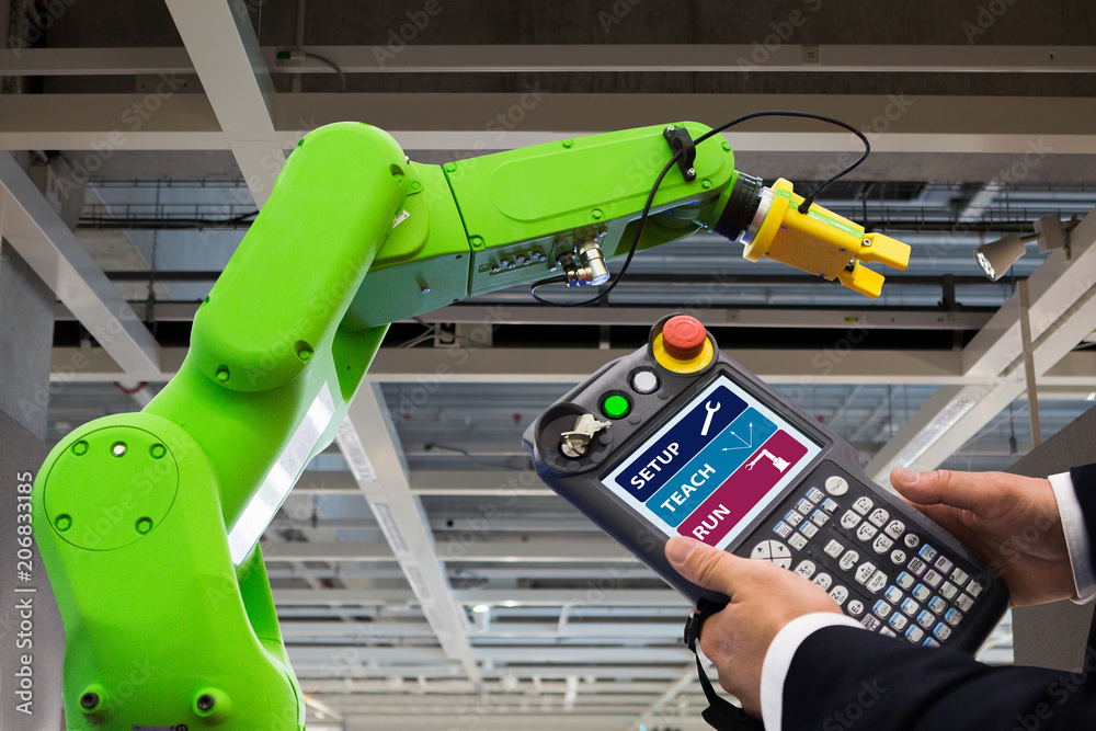 Poster Engineer with teach pendant device. Programming robot with robotic arm. Smart factory 