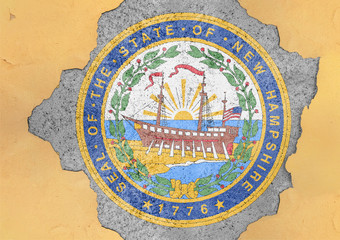 US state New Hampshire seal flag painted on concrete hole and cracked wall facade structure