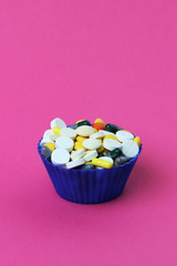 Different medicines in a cupcake form symbolizing modern world addiction to it