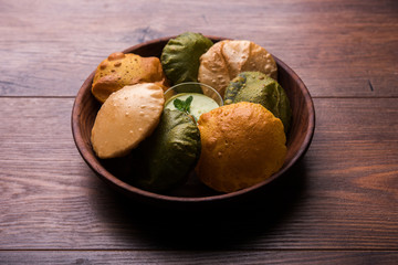 fried Plain Puri , spinach and masala poori served with green chutney, selective focus
