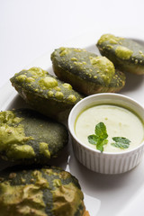 Palak Puri or Spinach Poori, indian breakfast food served with green chutney, selective focus