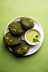 Palak Puri or Spinach Poori, indian breakfast food served with green chutney, selective focus