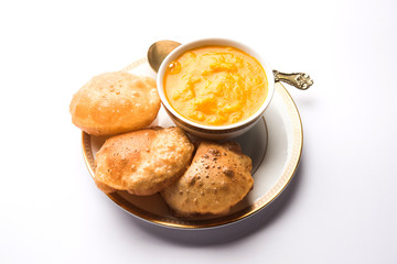Aam Ras Puri OR Alphonso  Mango pulp with fried Poori, selective focus