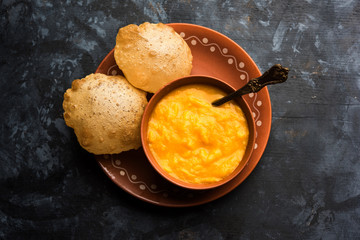 Aam Ras Puri OR Alphonso  Mango pulp with fried Poori, selective focus