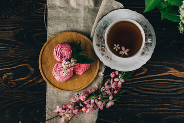 marshmallow, flowers, Cup of tea on dark background