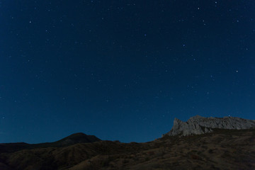 Fototapeta na wymiar Rocks of the extinct volcano Karadag in the Crimea in night
