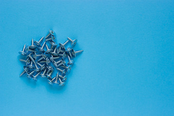 A bunch of nails on a blue background. Place under the text