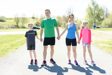 Parents with children sport running together outside