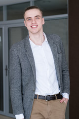 young handsome smiling business man. successful stylish banker or broker. corporate worker