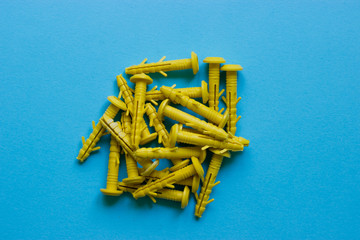 Yellow nails, caps on a blue background. Place under the text