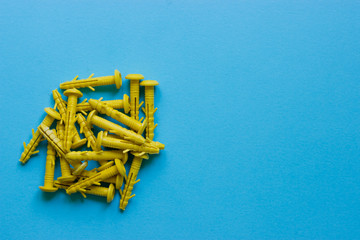 Yellow nails, caps on a blue background. Place under the text