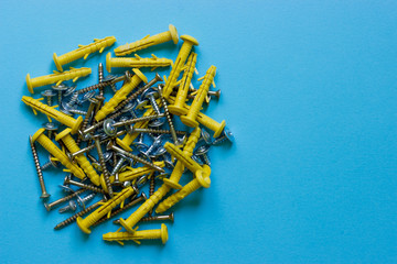 A bunch of different nails on a blue background. Place under the text