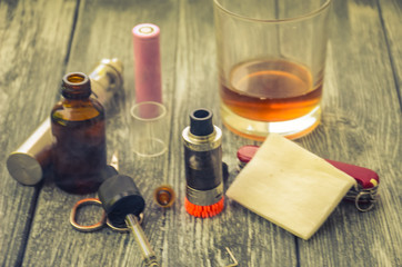 Still life with e-cig and jiuce on the wooden background