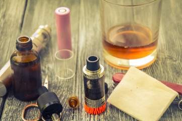 Still life with e-cig and jiuce on the wooden background