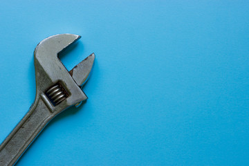 A big wrench on a blue background. Place under the text