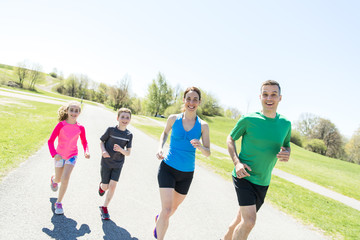 Parents with children sport running together outside