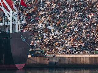 scrap metal pile junk waste waiting to be shipped on a ship