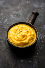 Amrakhand OR Mango Shrikhand / srikhand is popular Indian dessert served with saffron toppings in a bowl