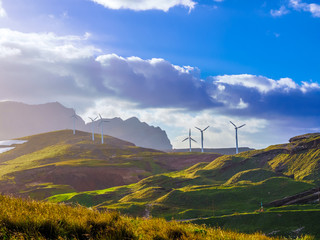 Windmills on green land of Madeira island, generating free electrical energy. Portugal