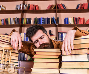 Teacher or student with beard fall asleep on books, defocused. Overstudied concept. Man on sleeping...