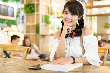 Portrait of beautiful Asian young woman smile and good feeling in workout time in coffee shop.Relaxing and happiness concept.
