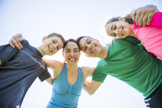 Parents With Children Sport Running Together Outside