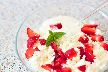 Tasty food. A dish of fresh strawberries and cottage cheese. Vitamin supplement. Dietary and vegetarian product. Add healthy and nutritious food to your diet.