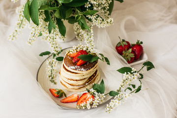 pancake, flowers and strawberries on the table
