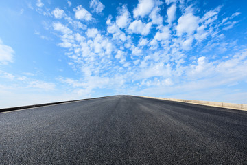 new asphalt road and sky clouds