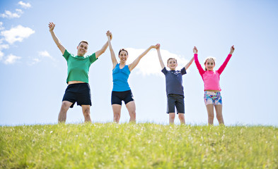 Parents with children sport running together outside