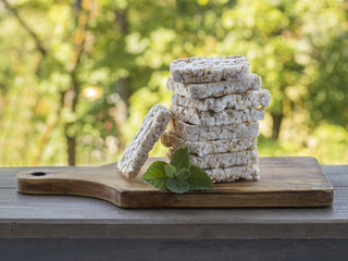 corn crackers on a wooden board.  © homohomozaza