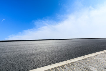 new asphalt road and sky clouds
