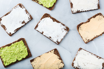 Variety of rye bread sandwiches with cream cheese, hummus, avocado