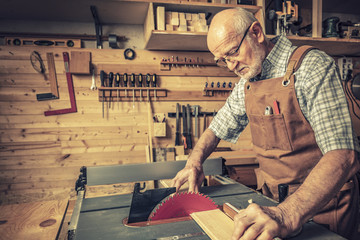 senior woodworker with tablesaw