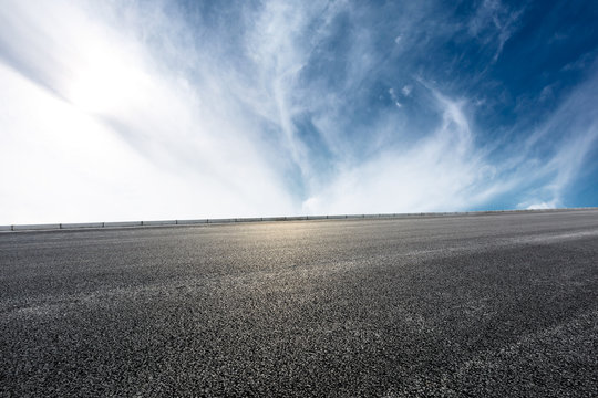 new asphalt road and sky clouds