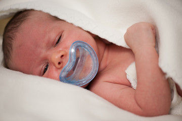 Baby boy sleep with soother in mouth