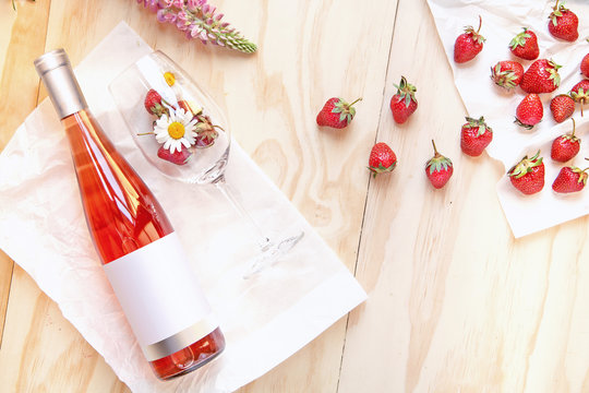 Bottle of rose wine wineglass strawberry