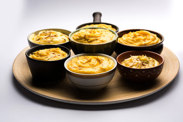 Shrikhand & Amrakhand served in different size bowl in group. Selective focus