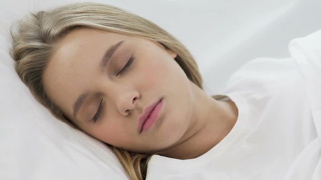 Cute teenage girl sleeping softly on comfortable orthopedic mattress, closeup